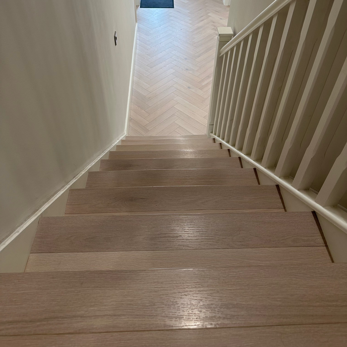 A staircase with glazed oak flooring and nosing, showing the texture and color of the wood.