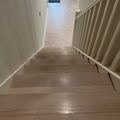 A staircase with glazed oak flooring and nosing, showing the texture and color of the wood.