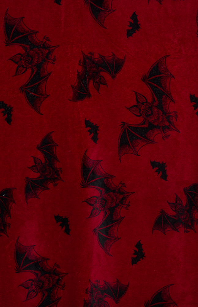 burgundy fleece blanket with black trim, featuring a black bats pattern.