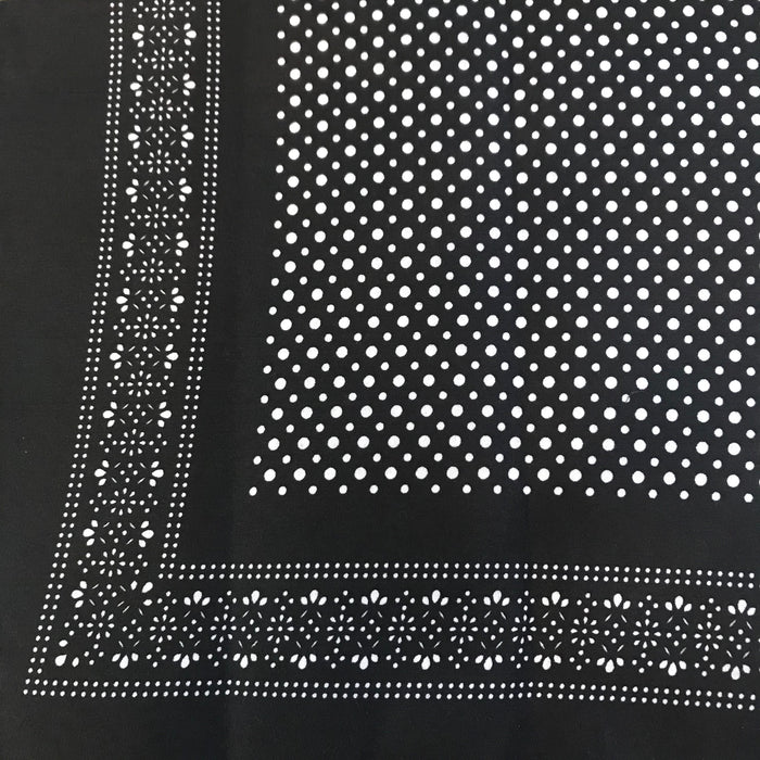 Black bandana with white polka dot patterns.