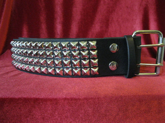 wide width black leather belt with four rows of silver pyramid studs. shows silver adjustable buckle