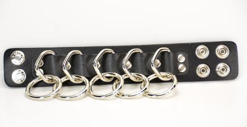 black leather bracelet with five silver d rings with five hanging silver o rings attached. shows snap closure