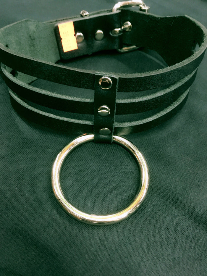 black leather three row strap sub bondage collar with large silver hanging o ring. shows adjustable buckle closure