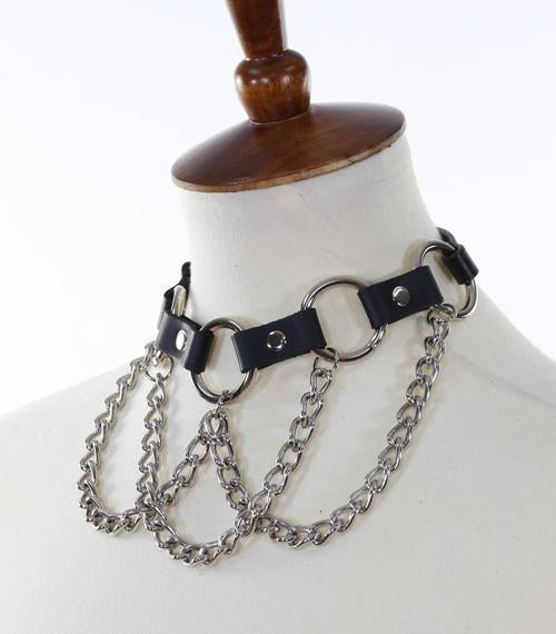 Black leather collar with multiple silver O rings with silver hanging chains.
