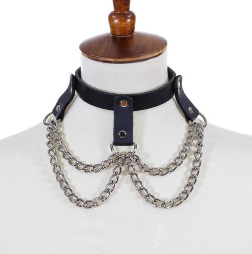 Black leather collar three hanging leather straps with silver D rings attached with two rows of silver chains hanging from the D rings.