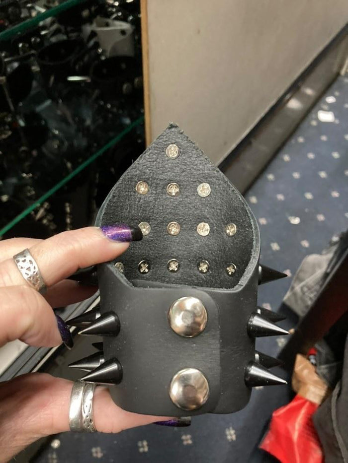 Triangular small black leather gauntlet bracelet with black cone spikes.