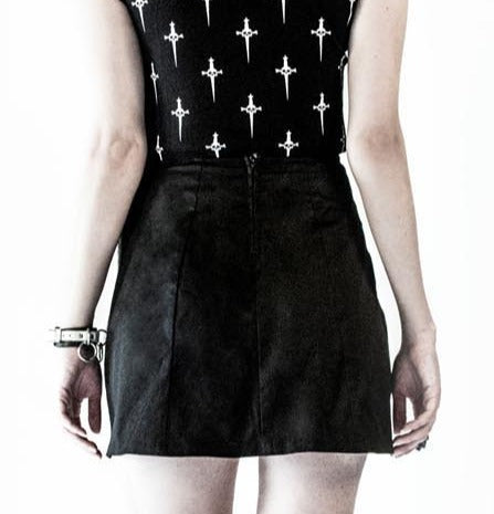 back of Black pleated skirt with front silver safety pin details.
