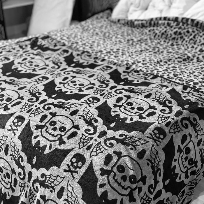 Spooky skulls, bats and webs black and gray damask pattern fleece throw blanket.