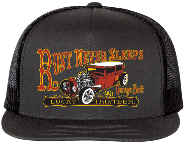 front of Black and orange/rust colored poplin-mesh snapback trucker cap. Hat has a rusty rat rod design called "Rust Never Sleeps" on the front and a "13" embroidered on the back left side. Backside has adjustable snap strap.