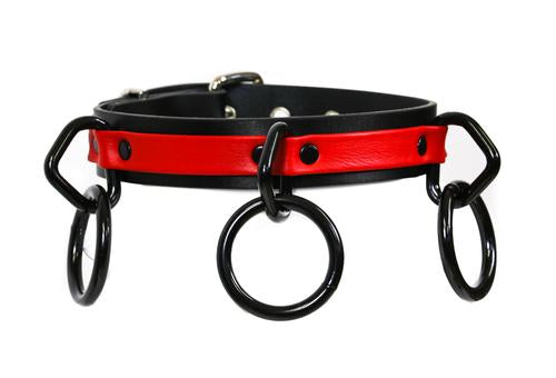 Black and red leather collar with three black D rings and hanging black O rings.