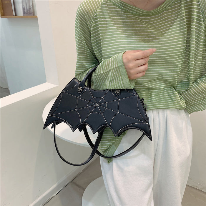 front side of purse showing White stitching spiderweb embroidery on front and hand straps