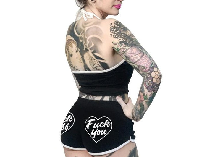women's Black shorts with white trim and white heart designs on both buttcheeks. left heart says "fuck off" and right heart says "fuck you." with white drawstring