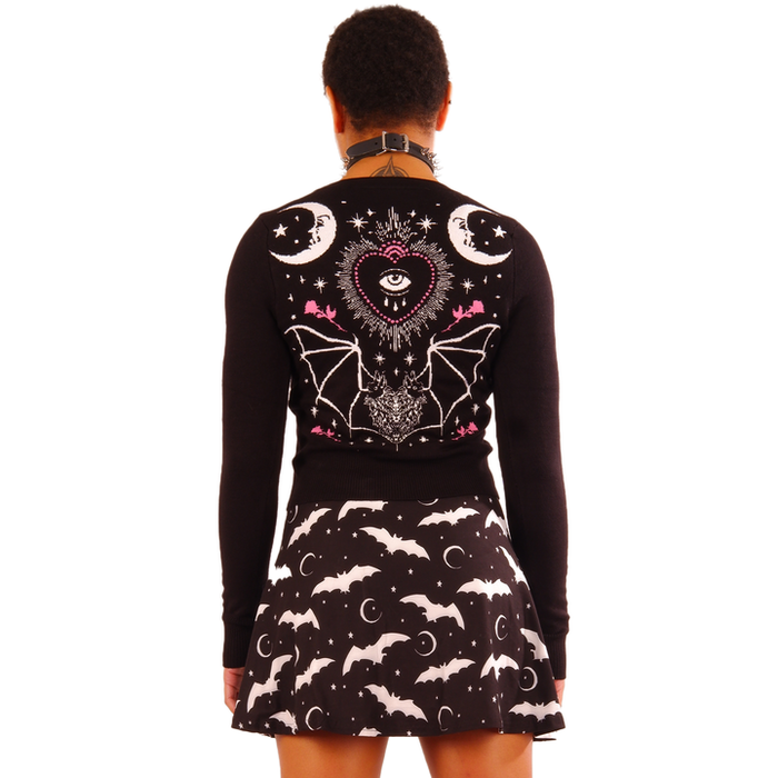 women's Black long sleeve short cropped cardigan with pink rose designs on outer wrists, white half moon and stars print on top left, and double half moon design on back with eyeball heart and bat