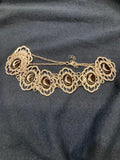 Brass colored multi crescent moon repeat pattern choker.