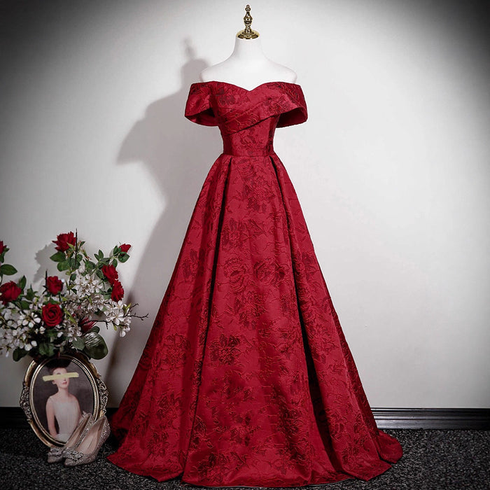 Burgundy off-shoulder jacquard ball gown with floral brocade pattern and sweetheart neckline.