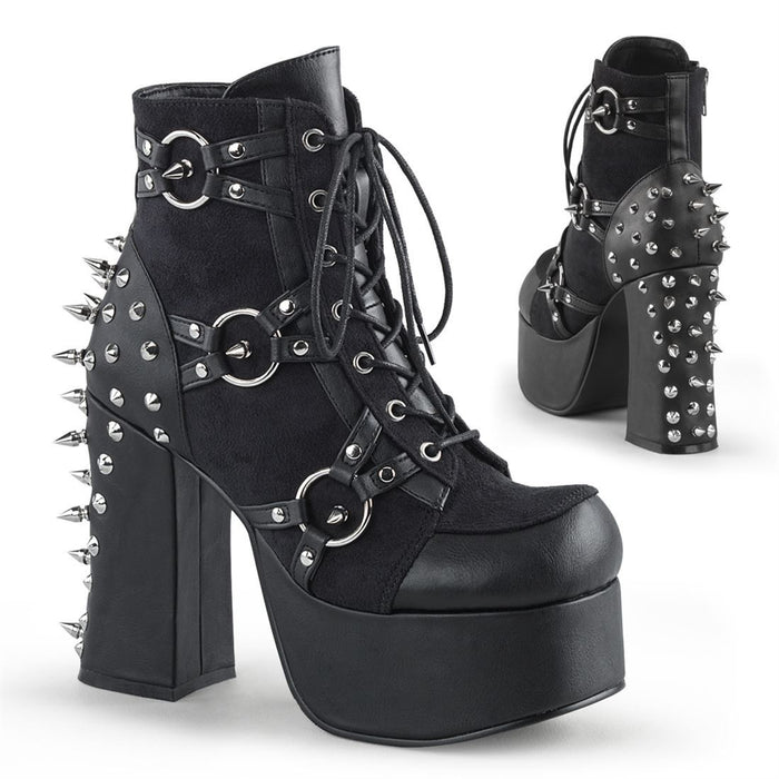 right and backside view of black vegan leather with suede panels 4.5 inch heel ankle boot with three O ring designs with spike in middle on each side of boot, tree spikes and s tuds on the back and 7 eyelet lace-up front