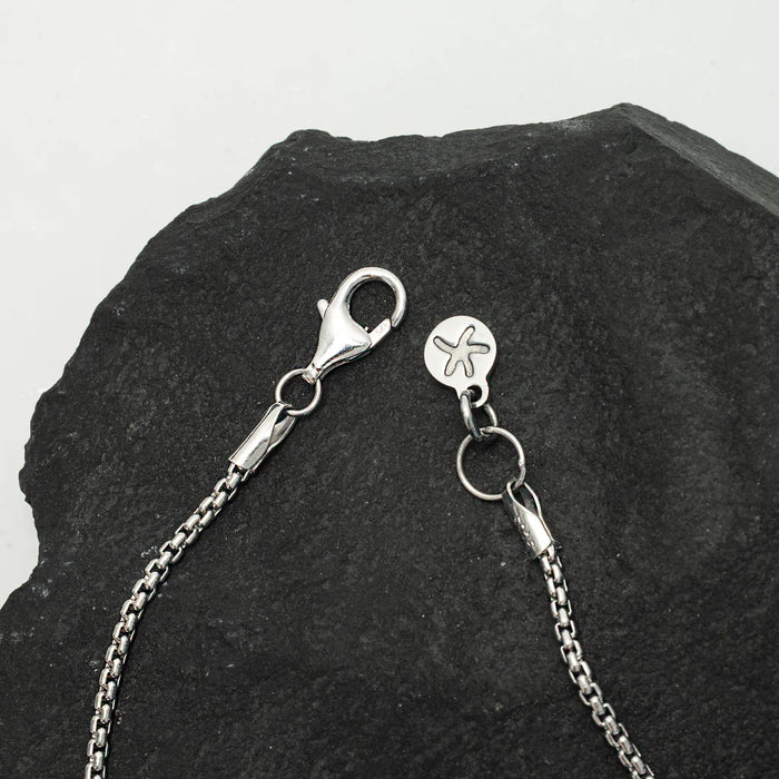 Close up of the clasp and its details from the Classic Cross Necklace in Sterling Silver | Gifts against human trafficking