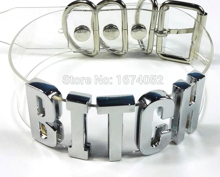 front of Clear PVC collar with silver letters on the front center spelling "BITCH". Collar has adjustable belt closure on the back.