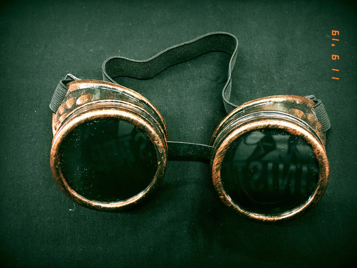 Copper steampunk goggles with black lenses.