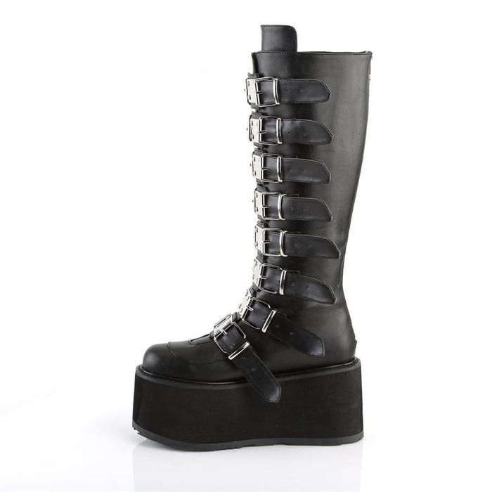 left side view of black vegan leather 3.5" platform knee high boot. Features 8 buckle straps w/ metal plates at center with back metal zip closure