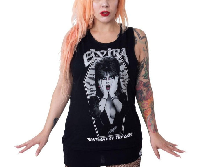 model wearing Elvira Mistress of the Dark tank top/sleeveless t-shirt. Shirt features bats and Elvira in a coffin shaped design.