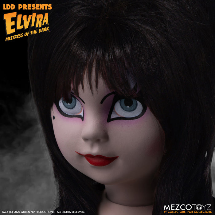 up close view of Elvira Living Dead Doll, with iconic black dress and batty, teased hair, and comes with a dagger that she can store in her waist belt. Stands 10” tall and features 5 points of articulation. Packaged in window box for display.