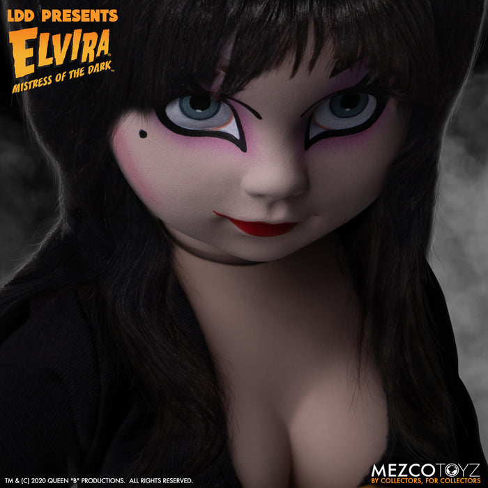 up close view of Elvira Living Dead Doll, with iconic black dress and batty, teased hair, and comes with a dagger that she can store in her waist belt. Stands 10” tall and features 5 points of articulation. Packaged in window box for display.