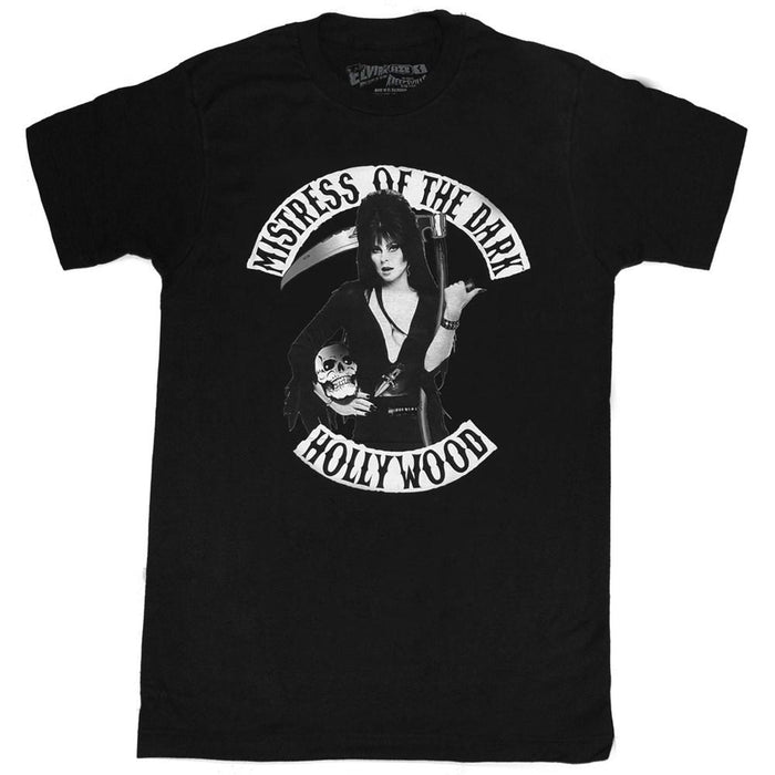 front of Black t-shirt with print of Elvira on front side. Print shows Elvira holding a skeleton and scythe. Top of shirt says "MISTRESS OF THE DARK" bottom says "HOLLYWOOD.