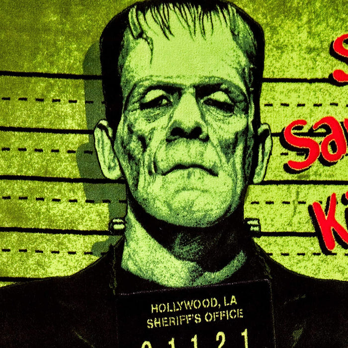 Micro plush fleece throw blanket features the iconic Frankenstein in a mug shot with green background; mirror image on back. Durable stitched-finished edge.
