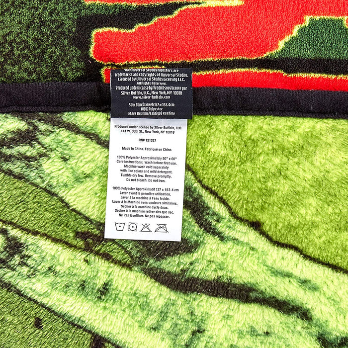 Micro plush fleece throw blanket features the iconic Frankenstein in a mug shot with green background; mirror image on back. Durable stitched-finished edge.