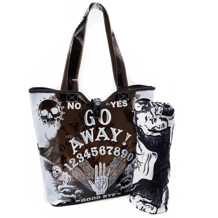See-through black PVC beach tote. Bag has white Ouija board "GO AWAY!" print on it. Bag has a double handle and snap closure. Towel in picture not included.