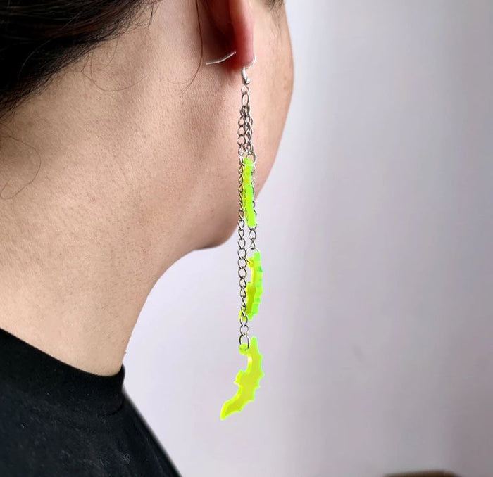 Three silver zinc alloy chains hanging from hook stud. Chains hang at different lengths with an acrylic green see-through bat hanging from each chain.