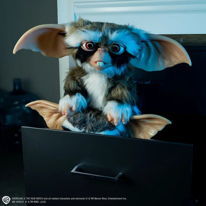 Lenny plush toy from Gremlins peeking out from behind a black surface