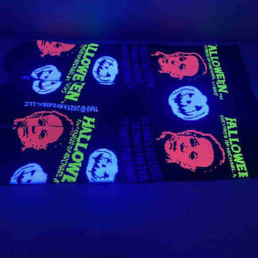 socks on display glowing under blacklight