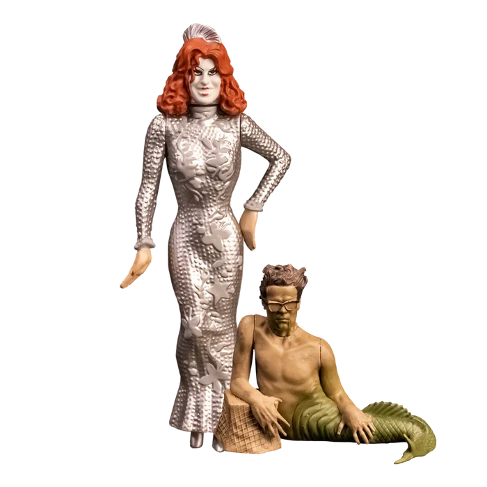 Two figurines, one in a silver dress and the other in a mermaid costume, on a white background