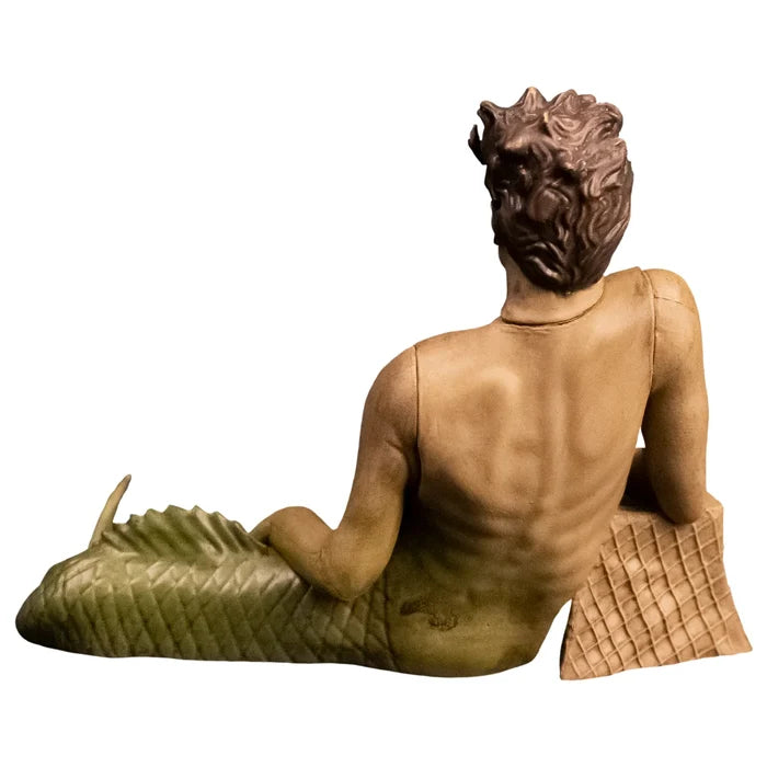 Two figurines, one in a silver dress and the other in a mermaid costume, on a white background