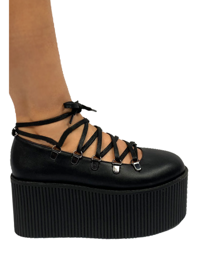 Black vegan leather upper, silver chrome hardware, black molded bottom. Top of Mary Jane laces up through D rings, and then ties around the ankle.