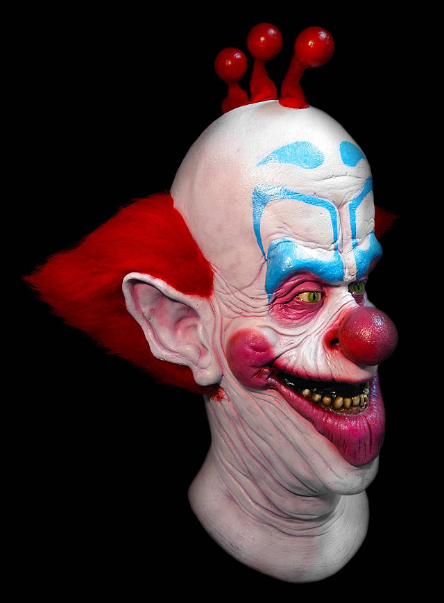 latex mask of slim the clown from killer klowns from outer space. mask has red hair on top and sides