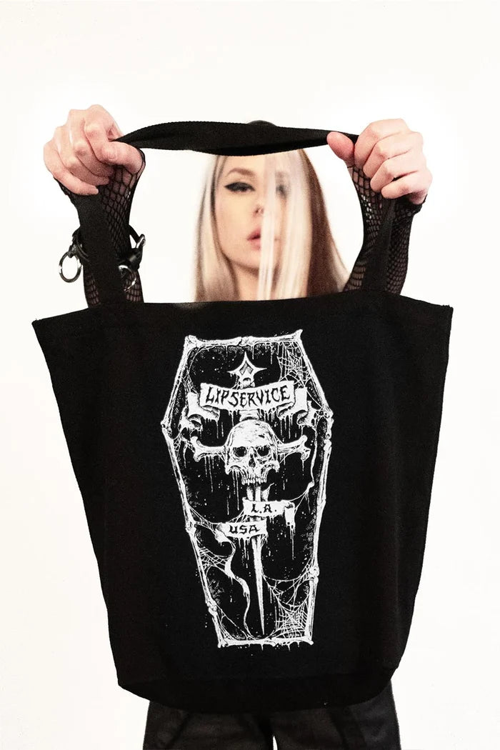 model holding tote bag