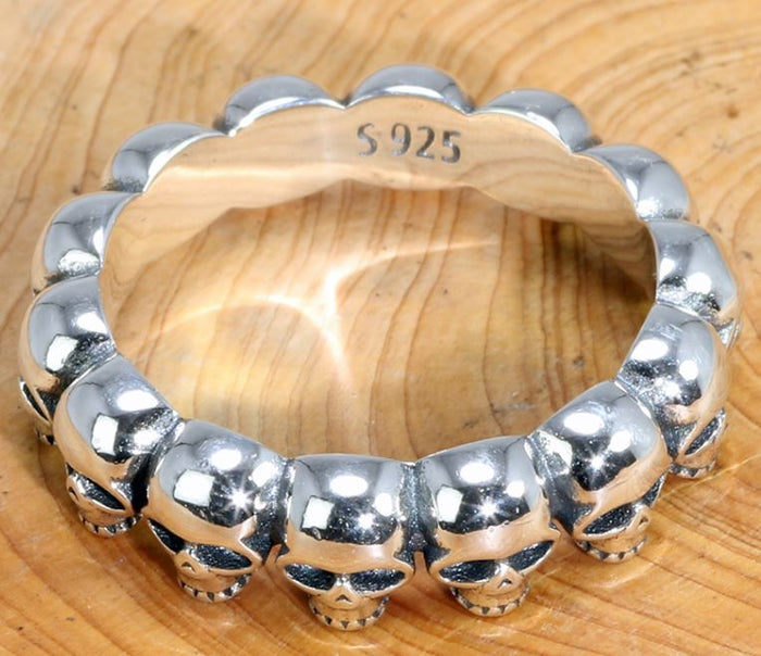 925 Sterling silver band ring with multi-skull design.