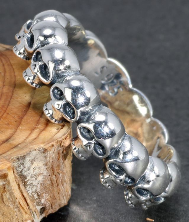 925 Sterling silver band ring with multi-skull design.