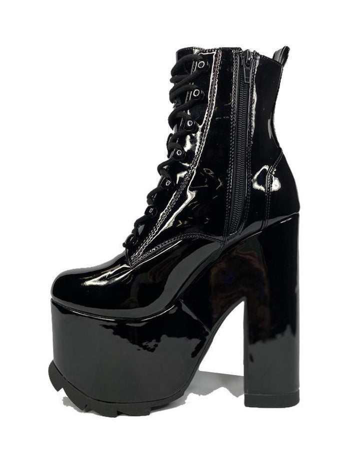 inner view of Black vegan shiny patent leather tall military style platform boot with black cotton laces and black inner zipper. Front of platform has a fanned grip for better stability when walking.