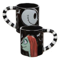 Black mugs (set of 2). One mug has Jack Skellington from a side profile and one mug has Sally from a side profile. Handles are black and white striped. Back of mugs have tombstones that read "Nightmare Before Christmas" with Zero underneath.