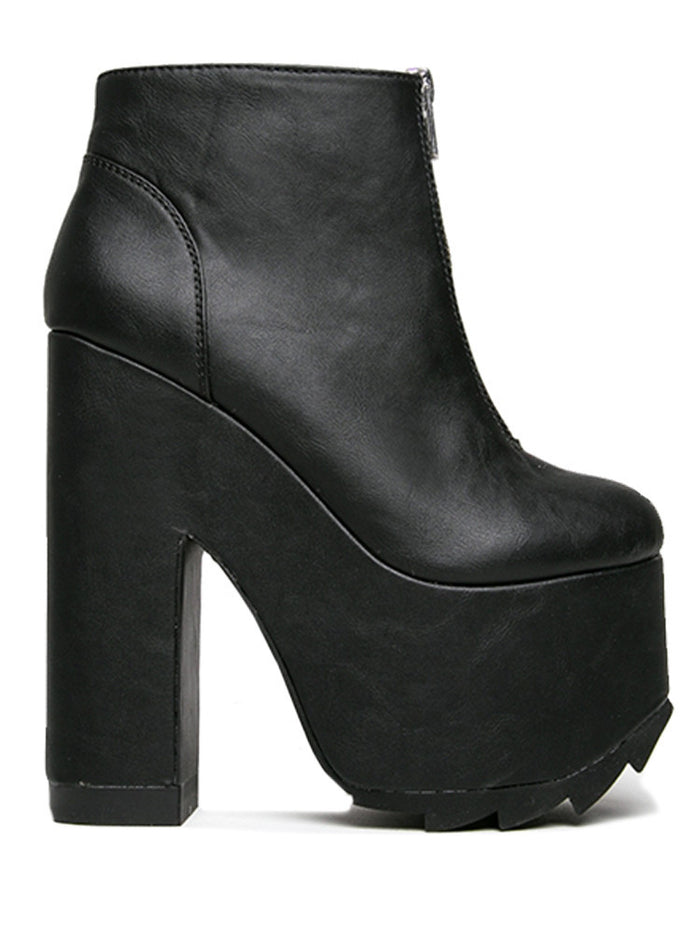 outer view of black vegan leather sleek 6.5" heel boot with silver front zip. Bottom of boot has a fanned front grip for better stability when walking.