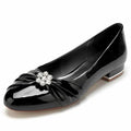 Elegant patent leather wedding shoes with a decorative flower embellishment for bridal wear