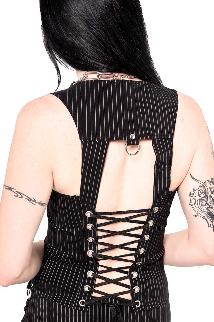 Model wearing a black pinstripe top on white background
