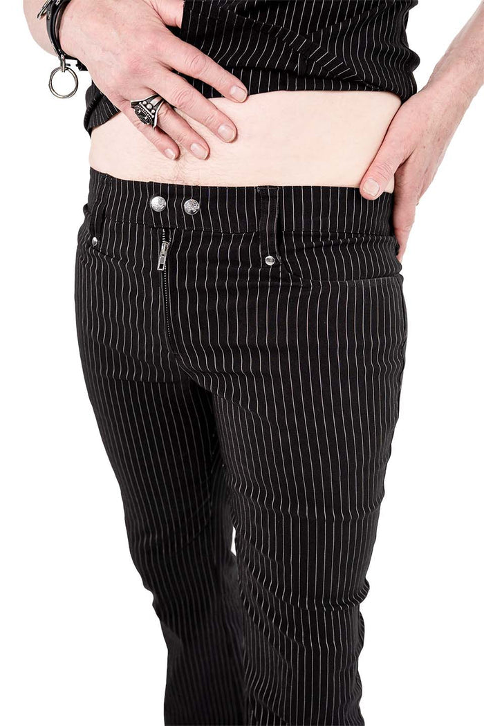 Model wearing black and white pinstripe pants worn n a white background
