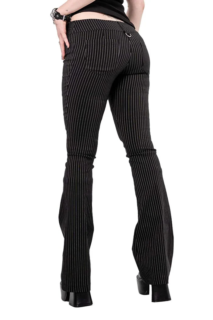 Model wearing black and white pinstripe pants on a white background