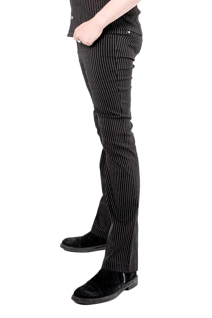 Model wearing black and white pinstripe pants worn n a white background