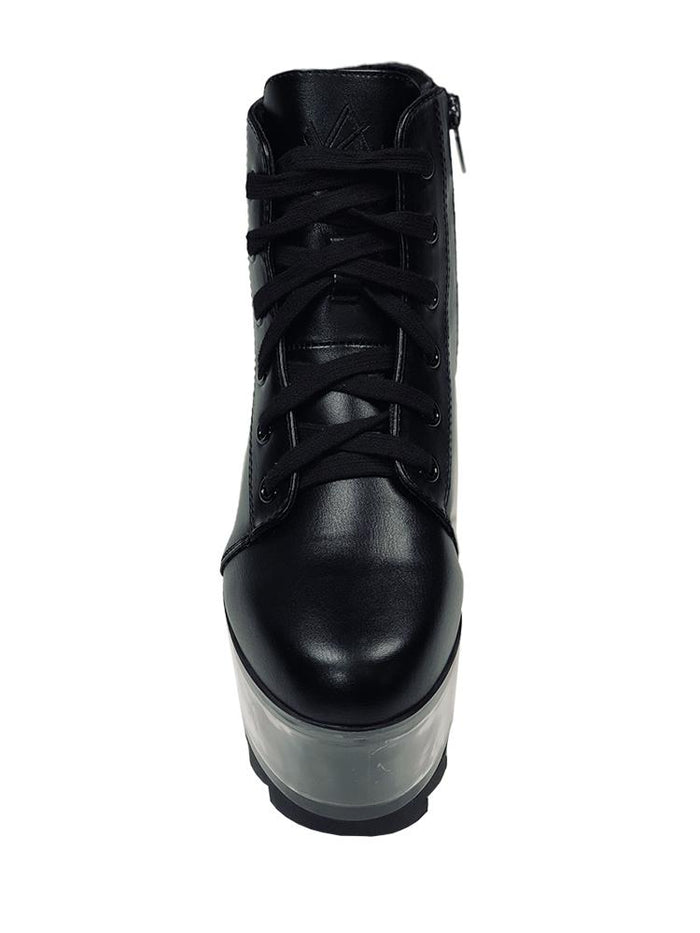 front view of black vegan leather platform shoe with clear plastic platform. Shoe looks like a sneaker, but is super tall! Clear plastic bottom has a Velcro foot bed opening, to insert toys, candy or fun stuff into the clear bottom of the shoe.